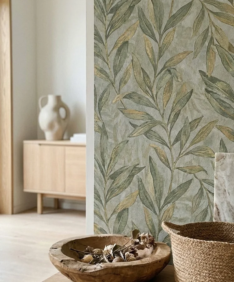 Close view of a softly layered botanical wallpaper texture in olive and stone tones