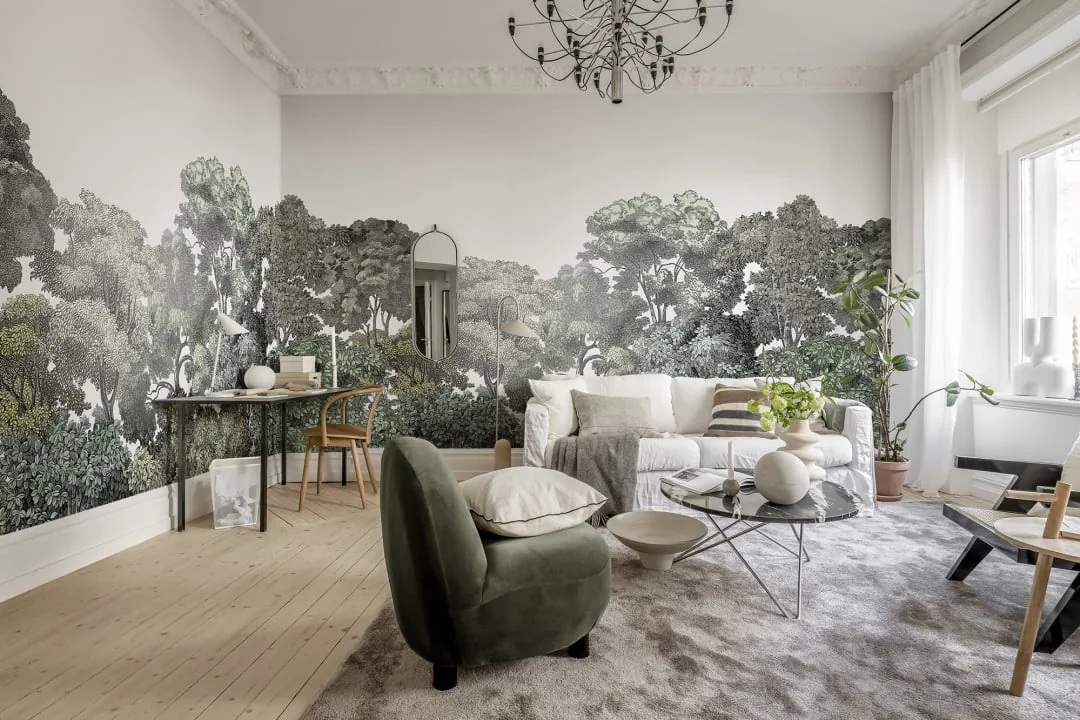 Airy living room framed by a continuous woodland mural wallpaper